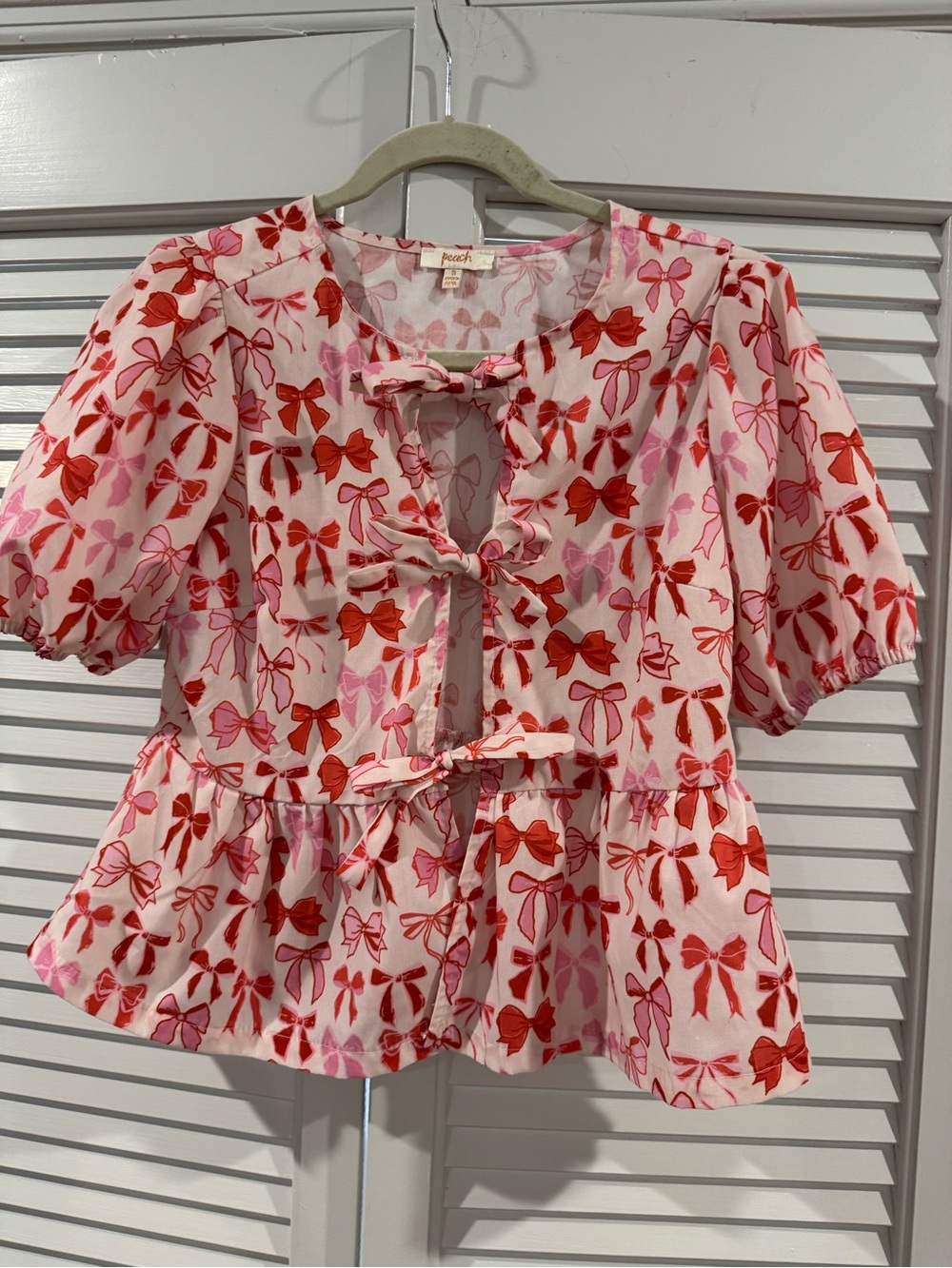 Peach Pink & Red Bow-Print Tie-Front Peplum Blouse